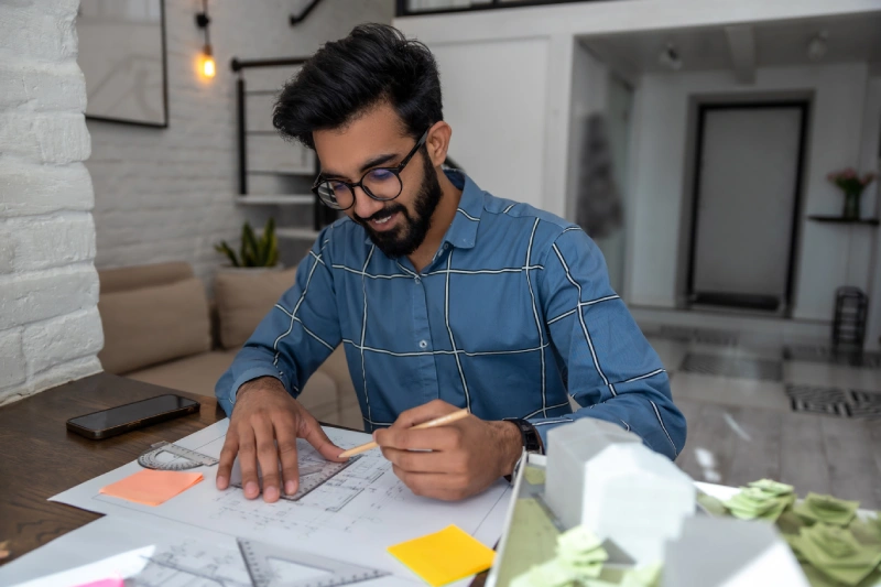 Young bearded man dealing with project